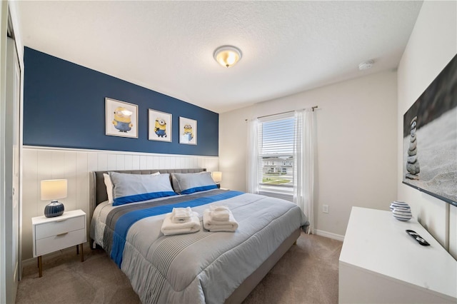 bedroom featuring carpet and a textured ceiling