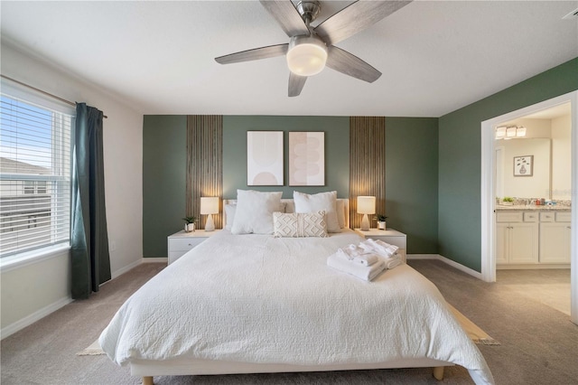 bedroom with light carpet, ensuite bath, and ceiling fan