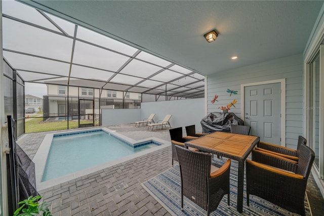 view of swimming pool with glass enclosure and a patio area