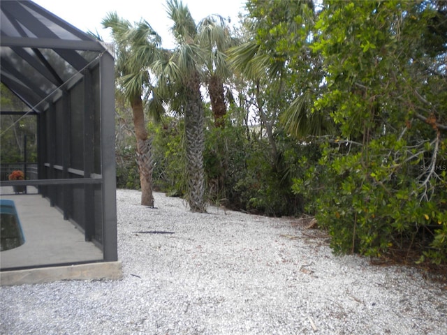 view of yard with glass enclosure