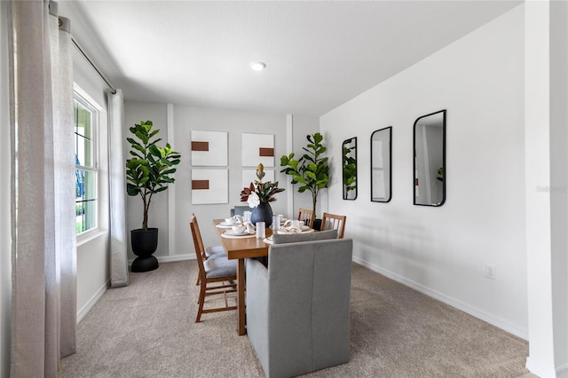 dining space featuring plenty of natural light and carpet floors