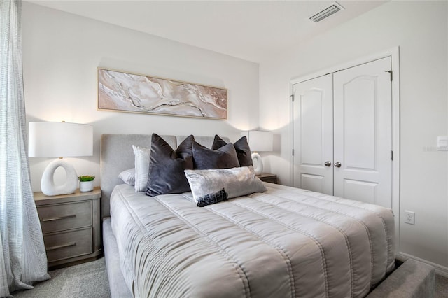 bedroom featuring light carpet and a closet