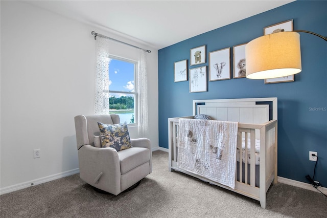 bedroom featuring carpet and a crib