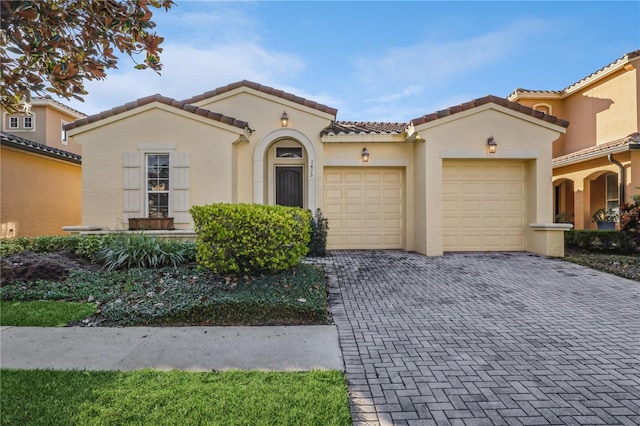 mediterranean / spanish-style home featuring a garage