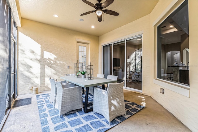 sunroom / solarium featuring ceiling fan