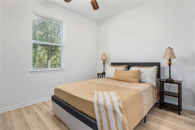 bedroom with ceiling fan and light hardwood / wood-style floors