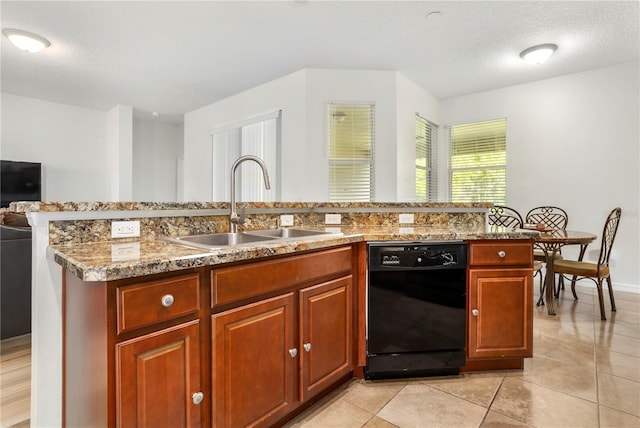 kitchen with dishwasher, sink, a textured ceiling, a center island with sink, and light tile patterned floors