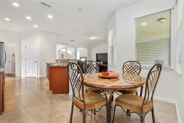 dining room featuring light tile patterned floors and a healthy amount of sunlight