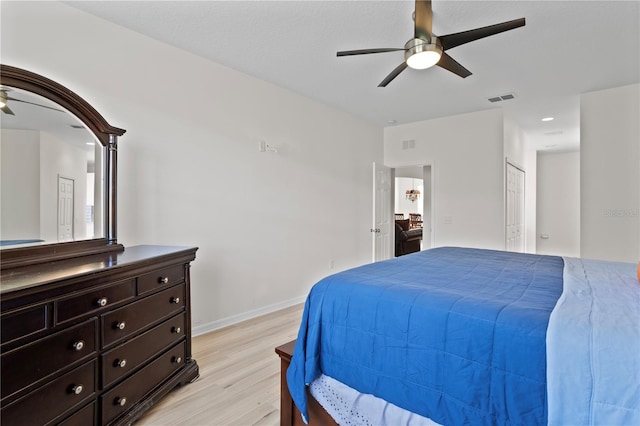 bedroom featuring ceiling fan, light hardwood / wood-style floors, and a closet