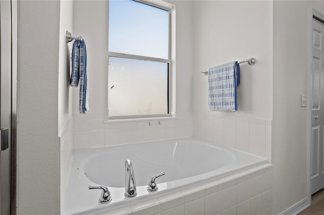 bathroom featuring a relaxing tiled tub