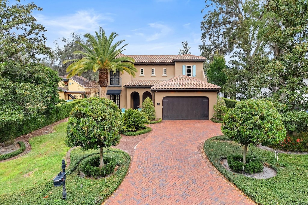 mediterranean / spanish house with a garage