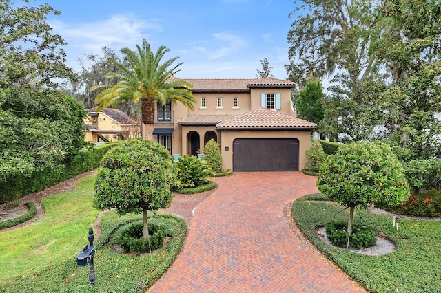 mediterranean / spanish house with a garage