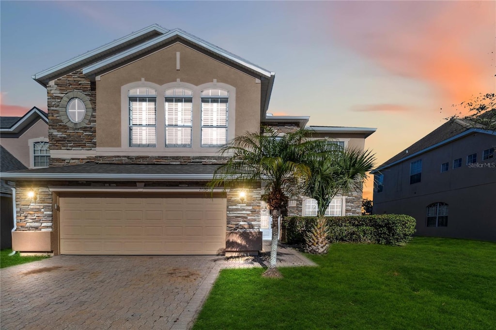2620 Sand Arbor Cir, Orlando, FL 32824 - view of front of home with a yard and a garage