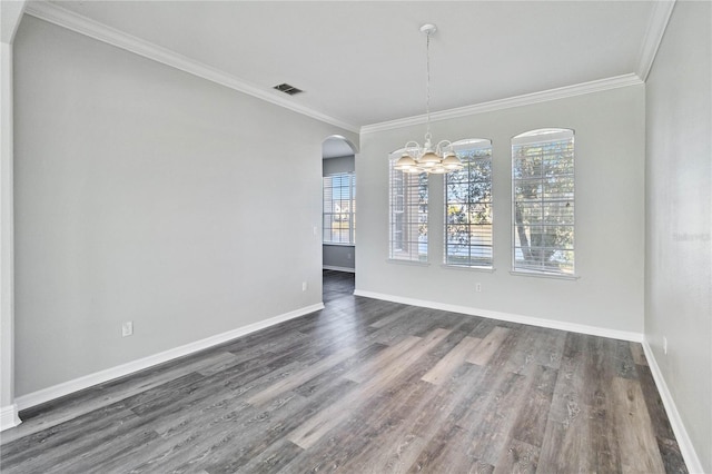 unfurnished dining area featuring dark hardwood / wood-style floors, crown molding, and an inviting chandelier