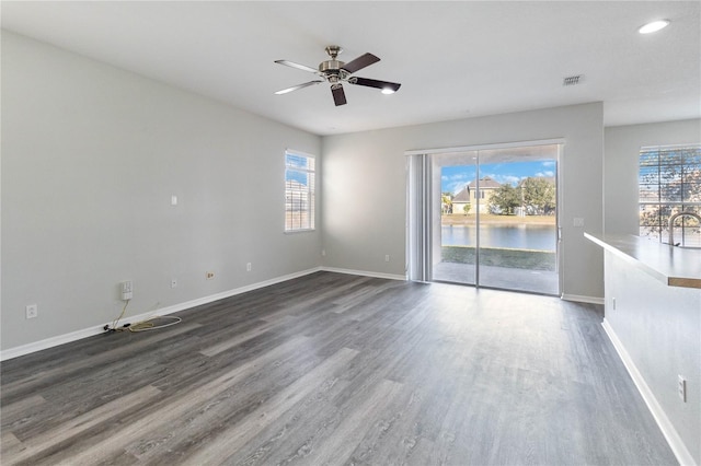 empty room featuring ceiling fan, sink, and dark hardwood / wood-style floors