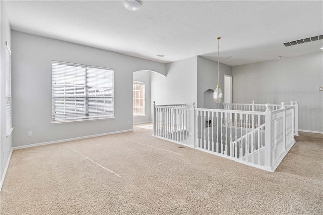 unfurnished room with light carpet