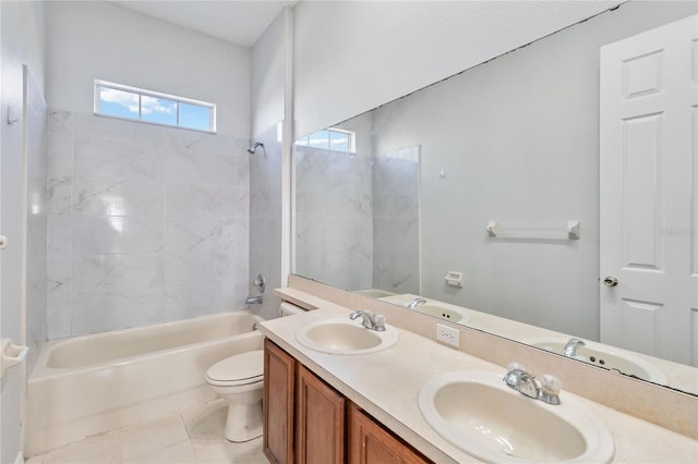 full bathroom featuring tile patterned flooring, vanity, toilet, and tiled shower / bath