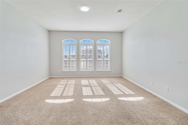 spare room featuring light colored carpet