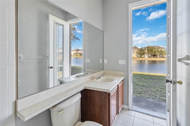 bathroom featuring vanity, tile patterned flooring, a water view, and toilet