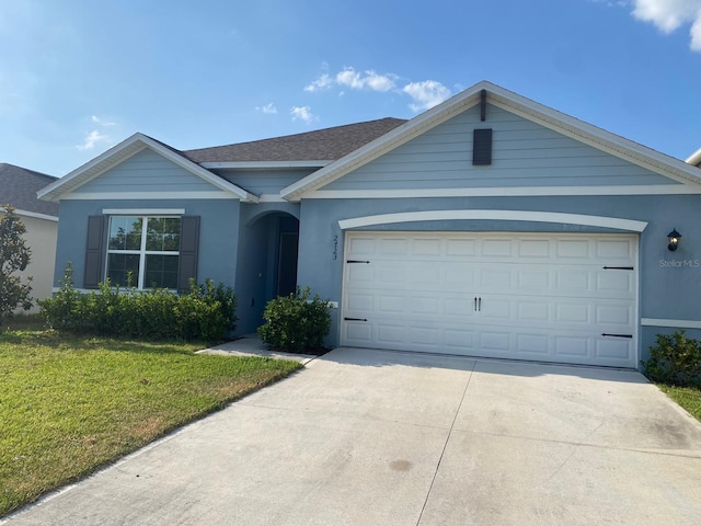 single story home with a garage and a front lawn