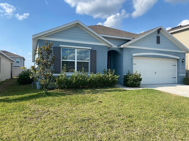 ranch-style house featuring a garage, driveway, a shingled roof, and a front yard