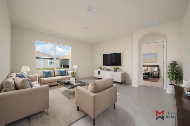 living room featuring light tile patterned flooring and visible vents