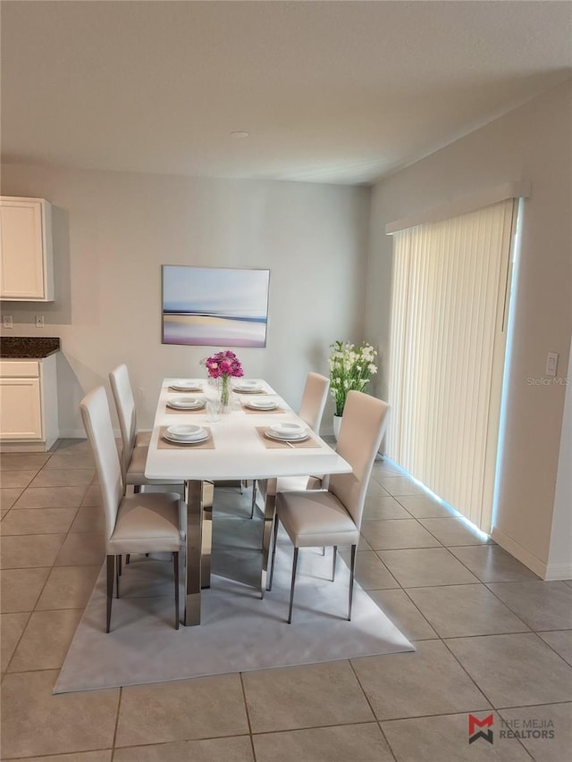 dining area with light tile patterned flooring