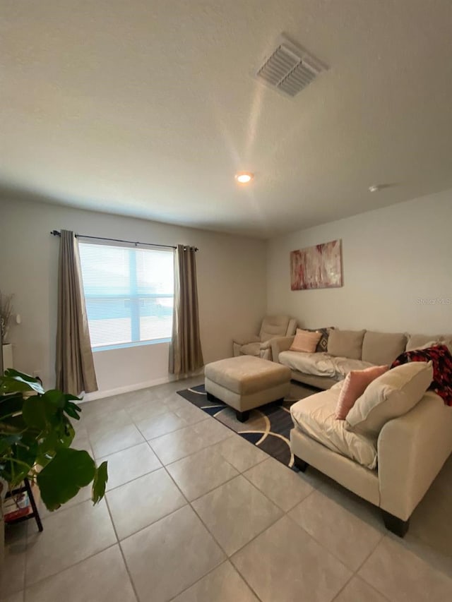tiled living room with visible vents and recessed lighting