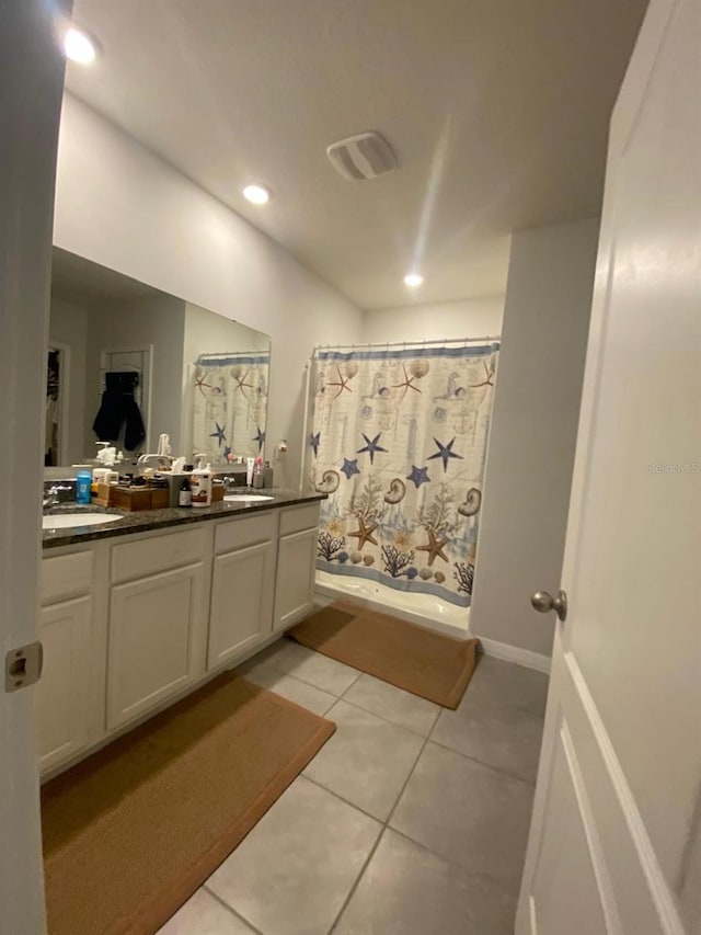 bathroom featuring recessed lighting, tile patterned floors, double vanity, and a sink