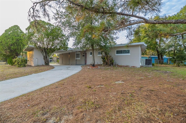 ranch-style home featuring a carport