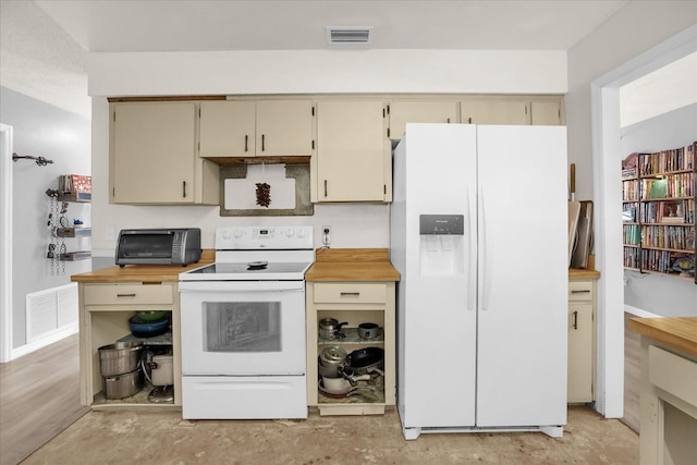 kitchen featuring butcher block counters, white appliances, and cream cabinets