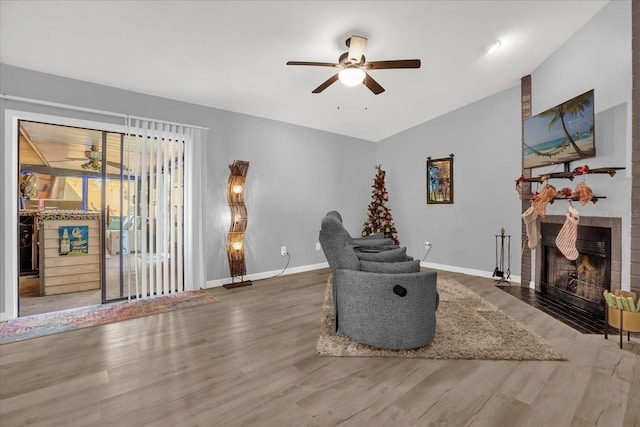 interior space featuring a fireplace, hardwood / wood-style floors, ceiling fan, and lofted ceiling