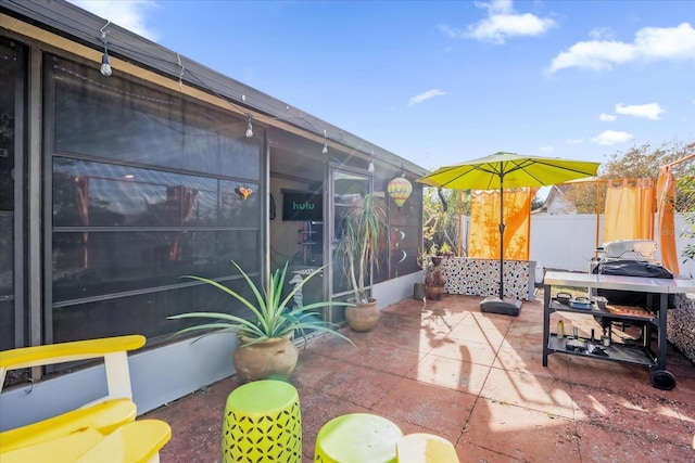 view of patio / terrace featuring a sunroom