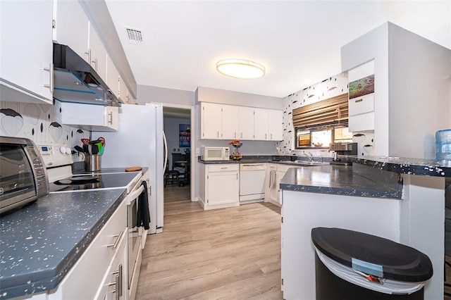 1608 Bomi Cir, Winter Park, FL 32792 - kitchen featuring white appliances, under cabinet range hood, a peninsula, white cabinetry, and light wood-type flooring