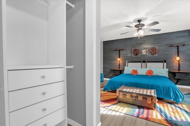 1608 Bomi Cir, Winter Park, FL 32792 - bedroom featuring a textured ceiling, baseboards, a ceiling fan, and wood finished floors
