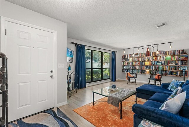 1608 Bomi Cir, Winter Park, FL 32792 - living area featuring wood finished floors, a textured ceiling, and track lighting
