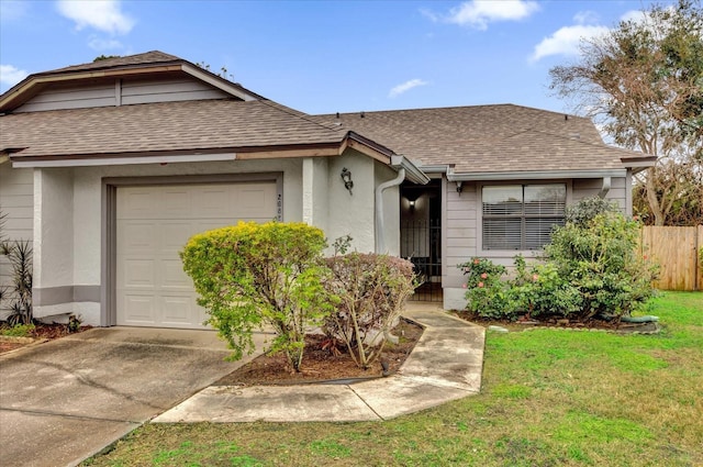 single story home with a garage and a front lawn