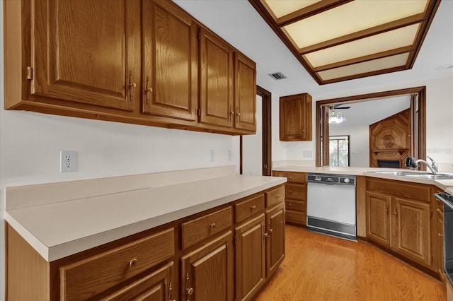 kitchen with dishwasher, sink, range, kitchen peninsula, and light hardwood / wood-style flooring