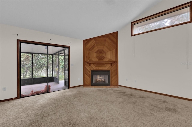 unfurnished living room featuring a fireplace, carpet, and vaulted ceiling