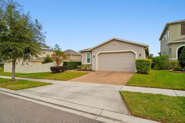 view of front of house featuring a garage and a front lawn