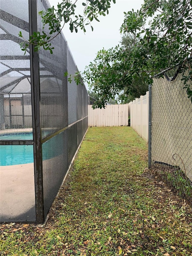 view of yard featuring a lanai and a fenced in pool