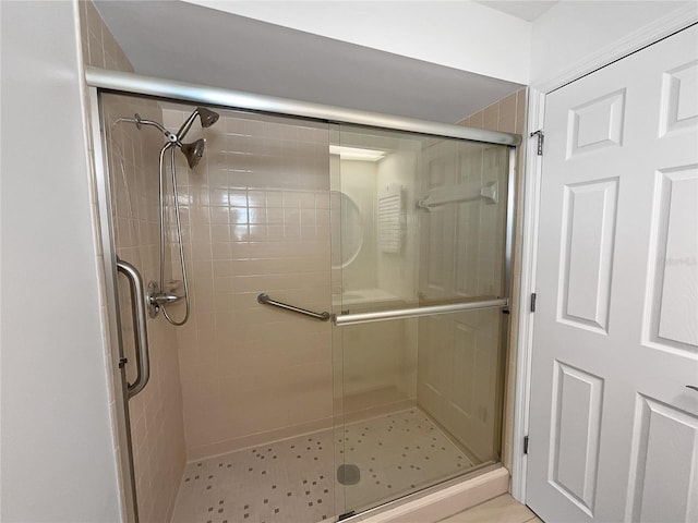 bathroom with a shower with shower door