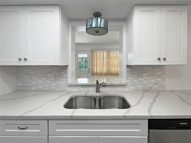 2448 S Daytona Ave, Flagler Beach, FL 32136 - kitchen featuring stainless steel dishwasher, white cabinets, tasteful backsplash, and light stone counters