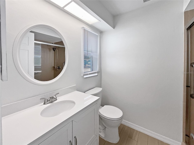 bathroom featuring vanity, hardwood / wood-style flooring, toilet, and an enclosed shower