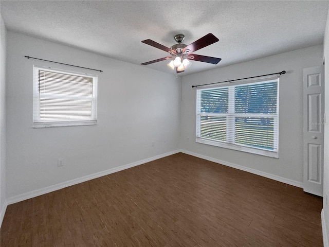 spare room featuring a textured ceiling, dark hardwood / wood-style floors, and ceiling fan