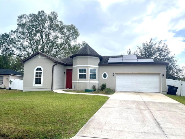 view of front of house with solar panels, a garage, and a front yard