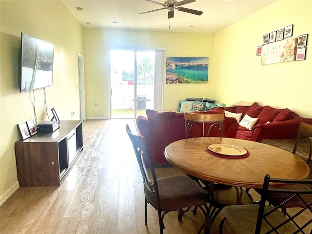 dining space featuring light wood-type flooring and ceiling fan