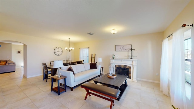 living room with light tile patterned floors and an inviting chandelier