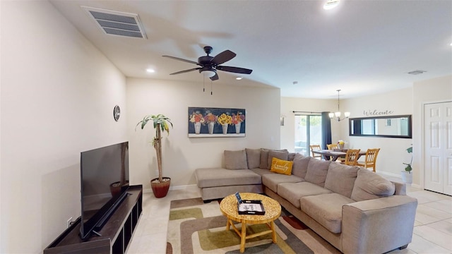 tiled living room featuring ceiling fan with notable chandelier