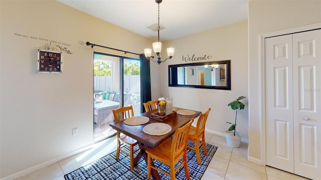 dining room with a notable chandelier and light tile patterned floors